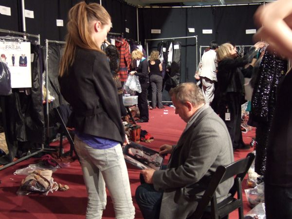 Backstage at Marc by Marc, Fabien Baron checks out the portfolio of Monica, also known as Jac